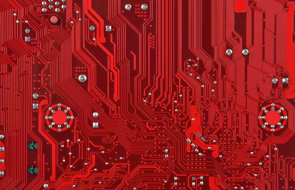 A red-printed circuit board with no components